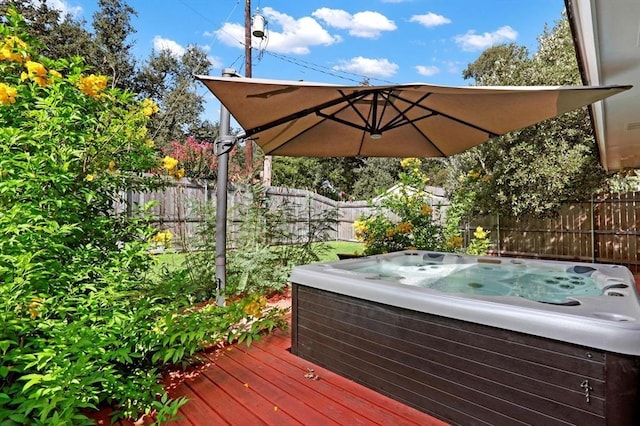 wooden deck featuring a hot tub