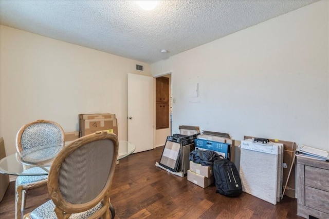 office with dark wood-type flooring and a textured ceiling