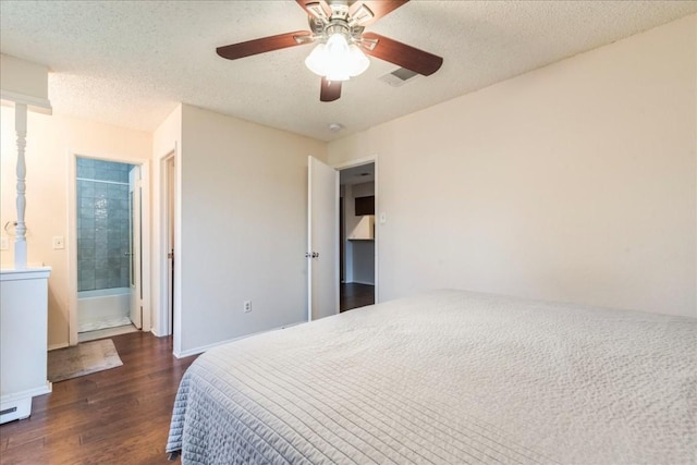 bedroom with a textured ceiling, dark hardwood / wood-style floors, and ceiling fan