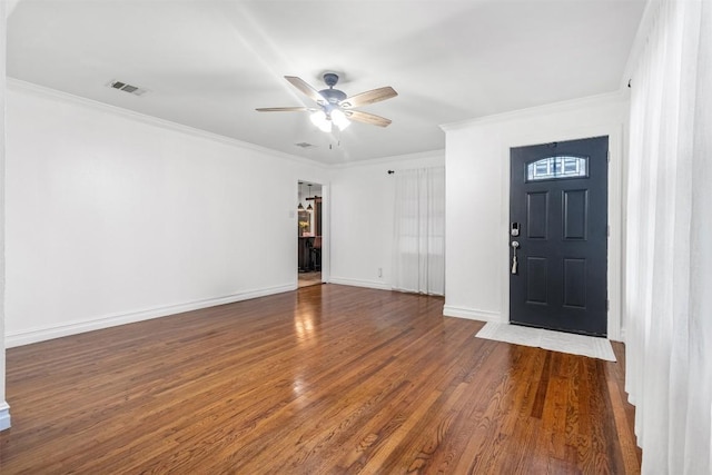 entrance foyer with crown molding and dark wood-type flooring