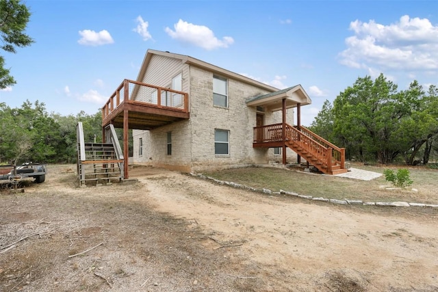 back of house with a wooden deck