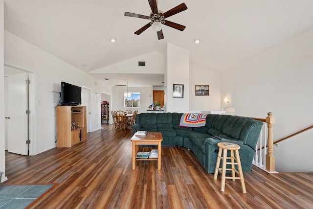 living room with ceiling fan, dark hardwood / wood-style floors, and high vaulted ceiling