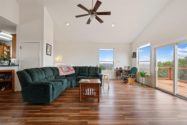 living room featuring dark wood-type flooring, high vaulted ceiling, and ceiling fan