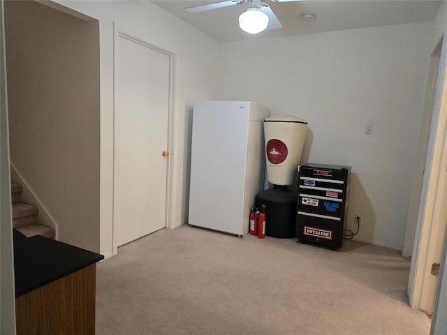 miscellaneous room with light colored carpet and ceiling fan