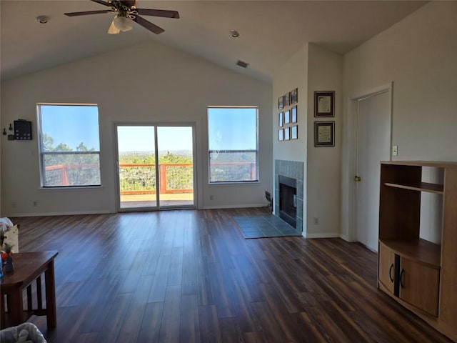 15101 Foy Dr, Austin, TX 78734 - unfurnished living room featuring a ceiling fan, dark wood-type flooring, lofted ceiling, and a tile fireplace