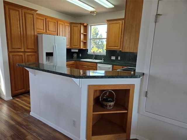 15101 Foy Dr, Austin, TX 78734 - kitchen with open shelves, white fridge with ice dispenser, dark wood-type flooring, dishwasher, and brown cabinets