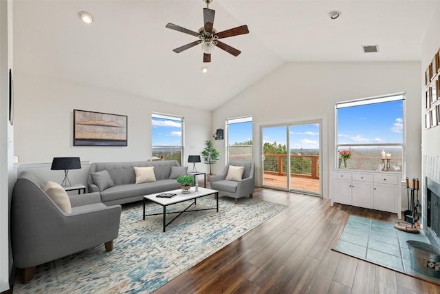 15101 Foy Dr, Austin, TX 78734 - living room with a ceiling fan, dark wood-style flooring, a fireplace, high vaulted ceiling, and recessed lighting