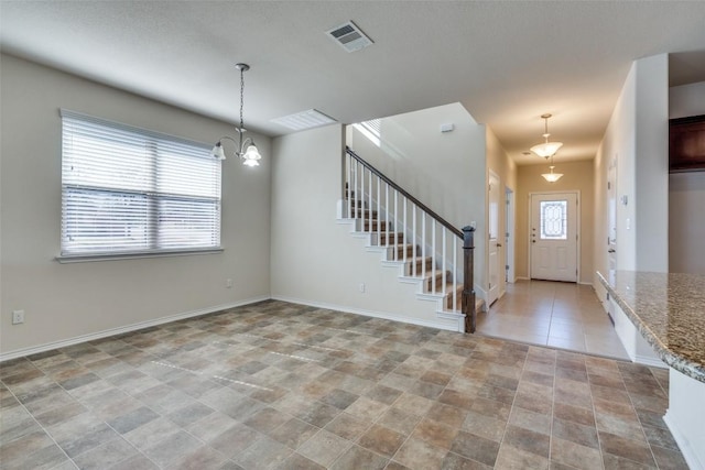 foyer featuring an inviting chandelier