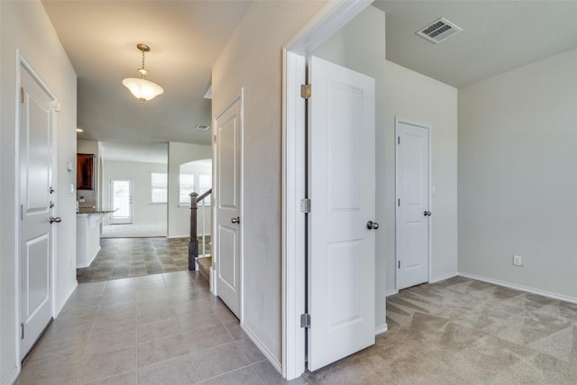 corridor with light colored carpet