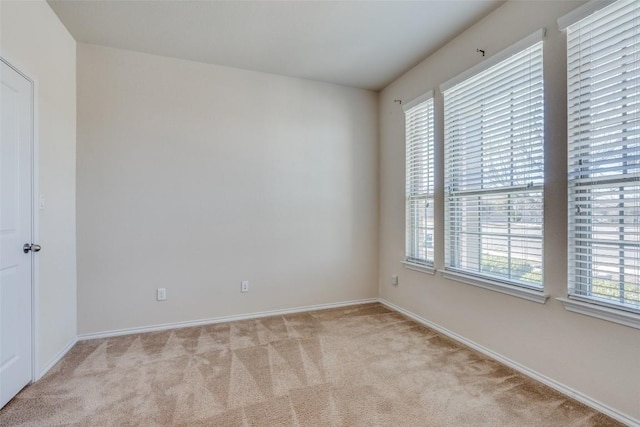 unfurnished room with light colored carpet