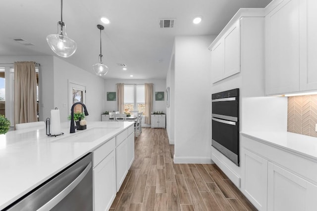 125 Jasmine Ln, Marble Falls, TX 78654 - kitchen featuring a sink, stainless steel dishwasher, light countertops, tasteful backsplash, and recessed lighting