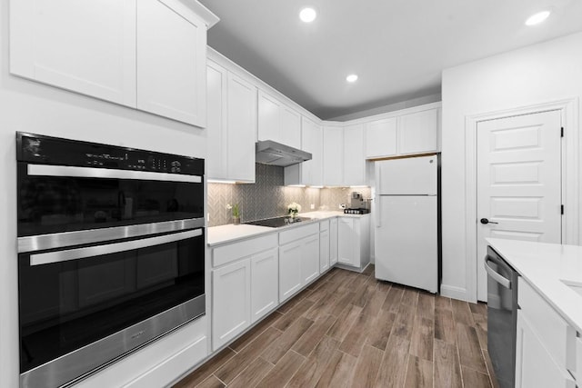 kitchen with stainless steel appliances, white cabinetry, dark wood-type flooring, and backsplash