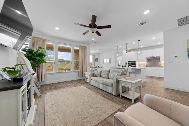 125 Jasmine Ln, Marble Falls, TX 78654 - living room with recessed lighting, ceiling fan, baseboards, and light wood finished floors