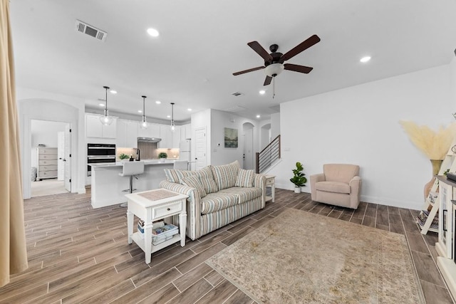 125 Jasmine Ln, Marble Falls, TX 78654 - living area featuring arched walkways, a ceiling fan, recessed lighting, wood finish floors, and baseboards