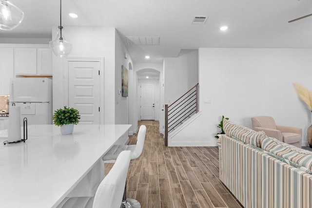 125 Jasmine Ln, Marble Falls, TX 78654 - dining space with arched walkways, wood finished floors, baseboards, stairway, and recessed lighting