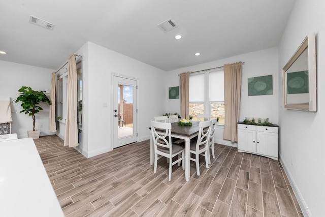 dining room with light hardwood / wood-style flooring and a wealth of natural light