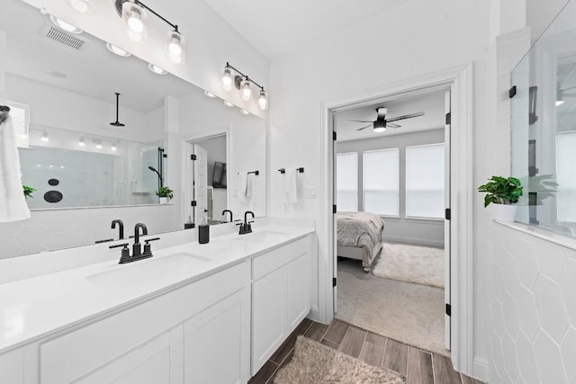 bathroom featuring walk in shower, ceiling fan, and vanity