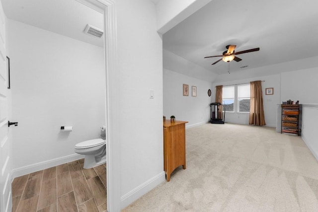 bathroom featuring hardwood / wood-style floors, toilet, and ceiling fan