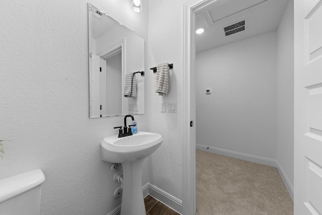 bathroom featuring toilet and sink