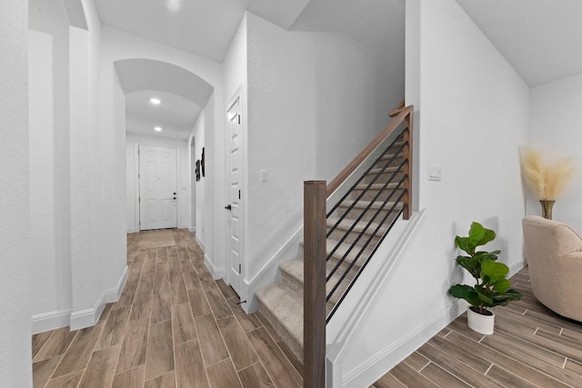 125 Jasmine Ln, Marble Falls, TX 78654 - staircase with arched walkways, wood tiled floors, recessed lighting, and baseboards