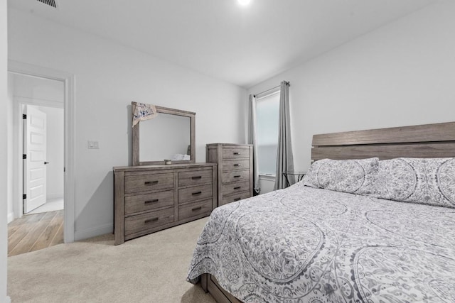 bedroom with light colored carpet