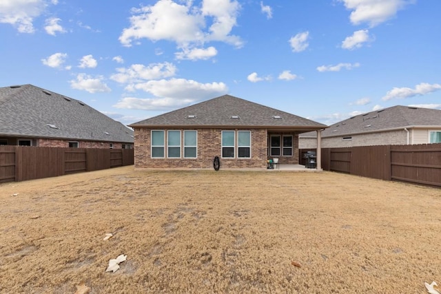 back of property featuring a patio and a lawn