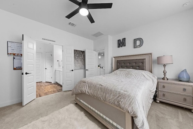125 Jasmine Ln, Marble Falls, TX 78654 - carpeted bedroom with baseboards, ensuite bath, and a ceiling fan