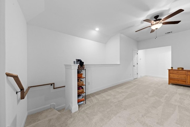 bonus room featuring vaulted ceiling, light carpet, and ceiling fan