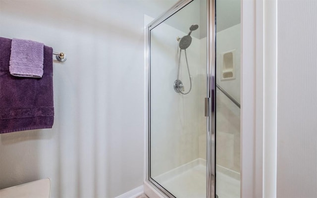 bathroom with a shower with door