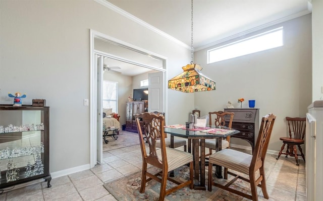 dining space featuring light tile patterned flooring, crown molding, and a wealth of natural light