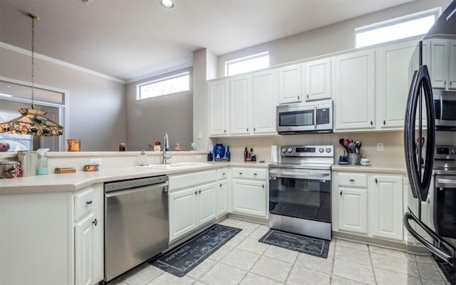 kitchen featuring sink, white cabinetry, light tile patterned floors, appliances with stainless steel finishes, and kitchen peninsula