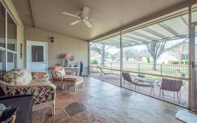 sunroom featuring ceiling fan