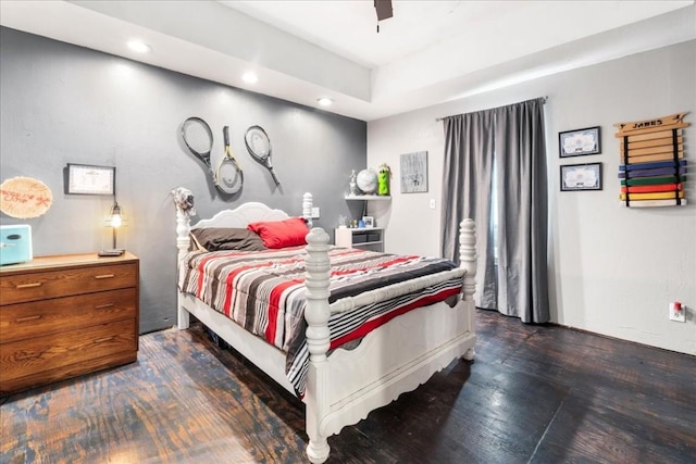 bedroom with dark hardwood / wood-style flooring and ceiling fan