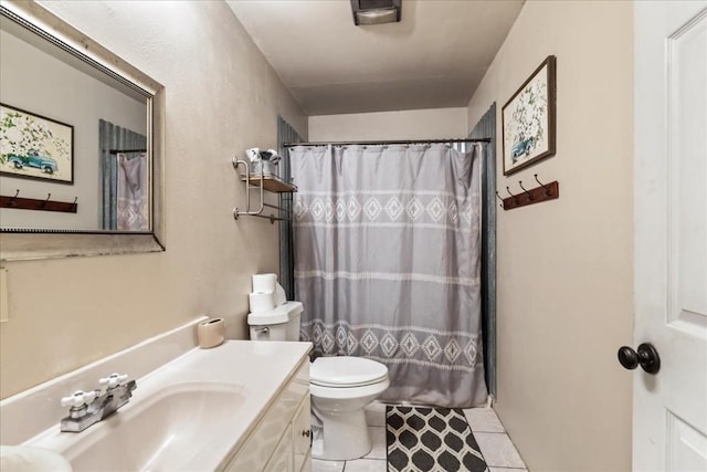 bathroom with tile patterned flooring, vanity, curtained shower, and toilet