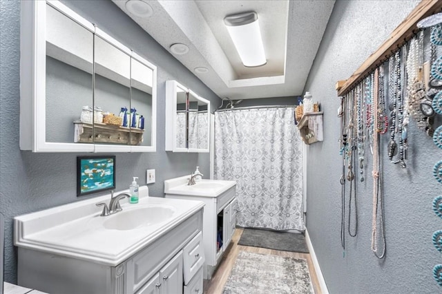 bathroom with vanity, hardwood / wood-style floors, and curtained shower