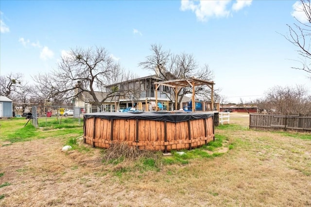 view of yard with a pergola and a covered pool