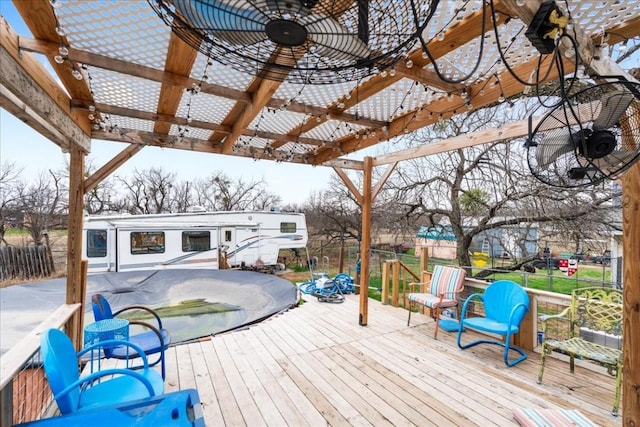 wooden terrace with ceiling fan and a pergola