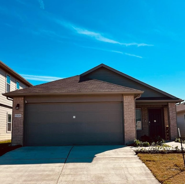 13120 Roving Pass, Elgin, TX 78621 - ranch-style house with driveway, a garage, and brick siding