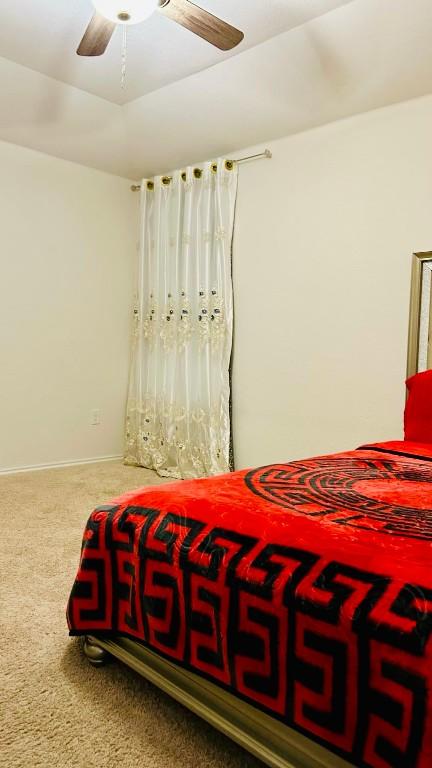 bedroom with ceiling fan and carpet