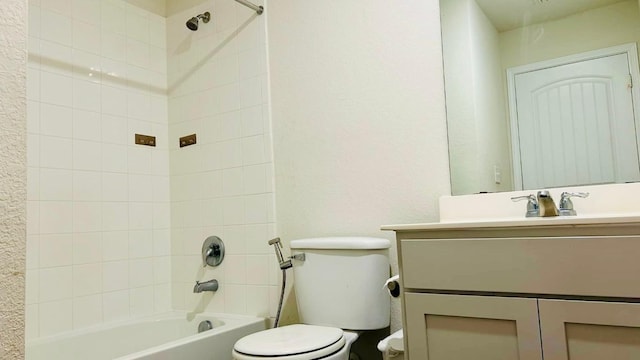 full bathroom with vanity, tiled shower / bath, and toilet