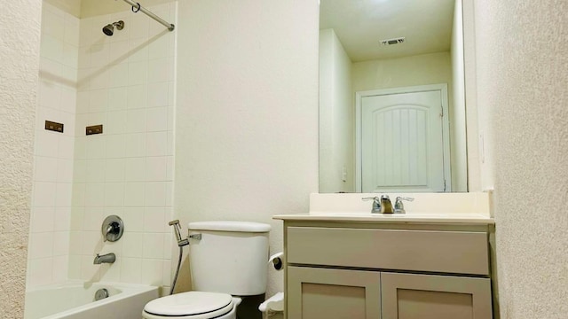 full bathroom with vanity, tiled shower / bath combo, and toilet