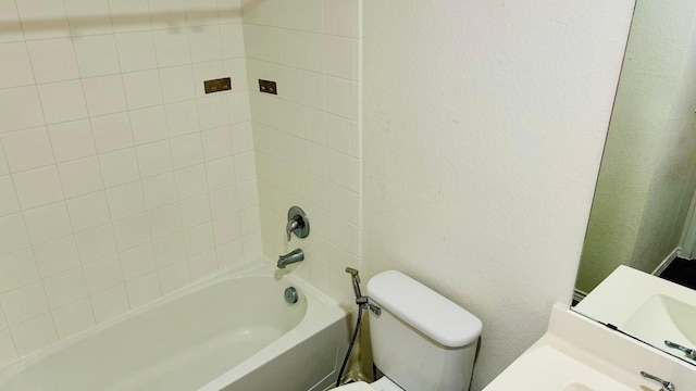 full bathroom with tiled shower / bath combo, vanity, and toilet