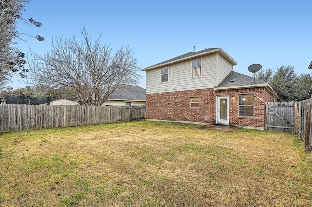 back of house with a lawn