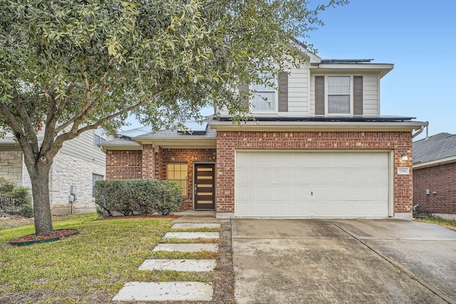 traditional-style home with solar panels, brick siding, a front lawn, and driveway