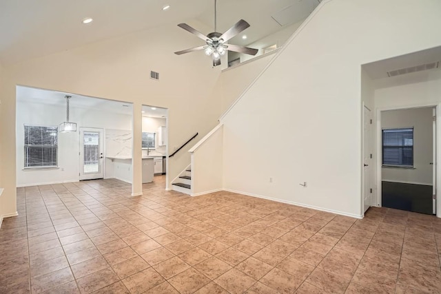 unfurnished living room featuring light tile patterned flooring, high vaulted ceiling, and ceiling fan