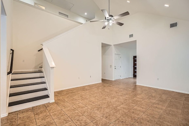 unfurnished living room with ceiling fan and high vaulted ceiling