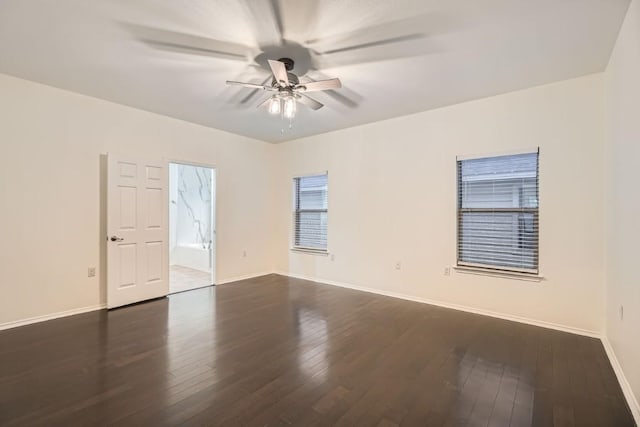 empty room with ceiling fan and dark hardwood / wood-style flooring