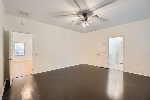 spare room featuring ceiling fan and dark hardwood / wood-style floors