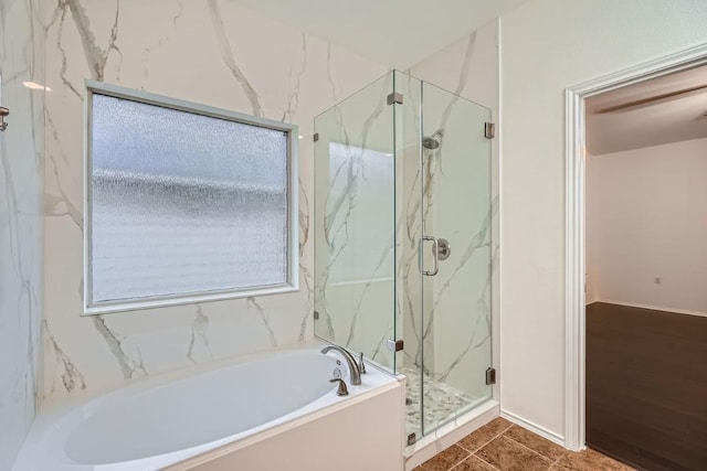 bathroom with independent shower and bath and tile patterned floors