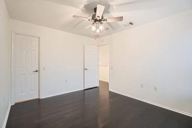 empty room featuring dark wood-type flooring and ceiling fan